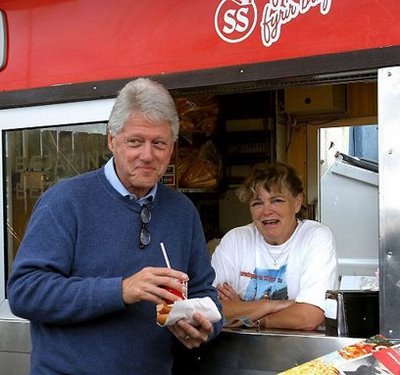 Hillary Pushing for Bill to Decrease Emissions...A defiant Clinton seen here sneaking a chili dog